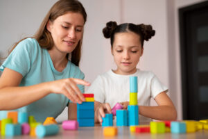 young-female-psychologist-helping-girl-speech-therapy